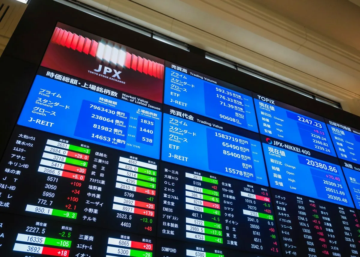 Tokyo stock exchange display nikkei index seoul trading board green close up microchip wafer tech surge